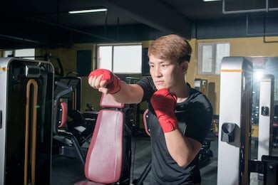 asian man training boxing at the fitness gym