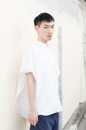 asian male model poses for pictures on the street