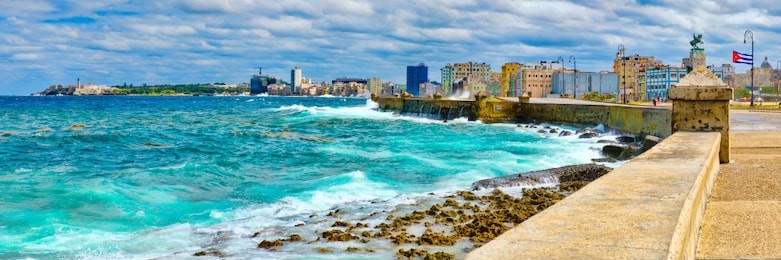 panoramic view of the havana skyline and the iconic malecon seawall with a stormy ocean