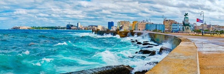panoramic view of the havana skyline and the iconic malecon seawall with a stormy ocean