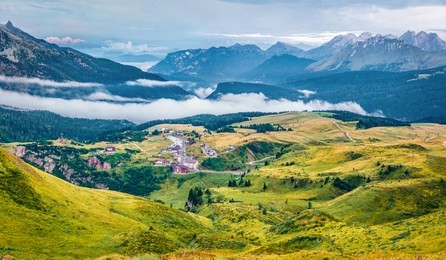aerial morning view of the top of rolle pass. picturesque summer scene of dolomites. foggy landscape of mountain valley, trentino province, italy, europe. traveling concept background.