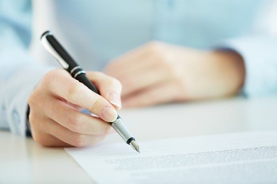 business worker signing the contract to conclude a deal
