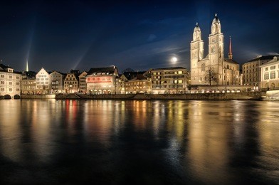 grossmuenster church and zurich city center by night. switzerland.