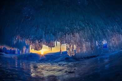 sunset in a cave grotto with icicles in the winter on olkhon island, lake baikal