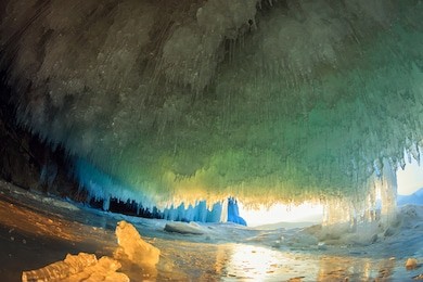 sunset in a cave grotto with icicles in the winter on olkhon island, lake baikal