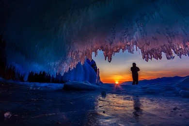 sunset in a cave grotto with icicles in the winter on olkhon island, lake baikal