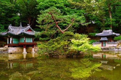 pavilions are around a pond where a tiny island is made, at secret garden of changdeokgung palace in seoul, korea.