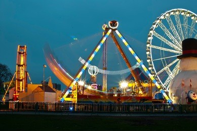 long exposure pictures of amusement park rides and wheels at night