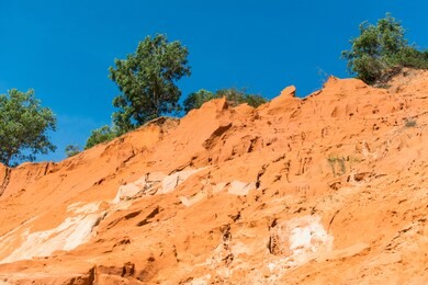 fairy stream canyon, the muddy waters of the fairy river (suoi tien) with red river, tropical oasis scenery of hills with limestone, sandstone plateaux. popular and famous landmark of mui ne, vietnam