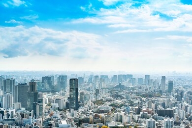 asia business concept for real estate and corporate construction - panoramic urban city skyline aerial view under bright blue sky and sun in tokyo, japan