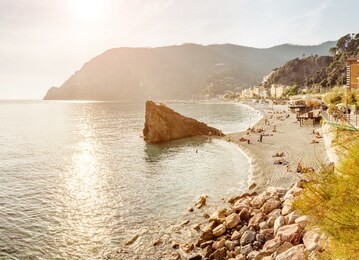 monterosso al mare beach with big cliff in cinque terre, ligurian coast, italy