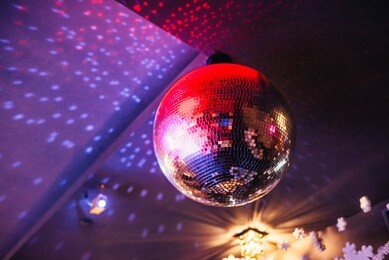 disco ball with bright rays, night party background photo