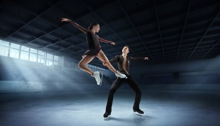 figure skating pair in ice arena