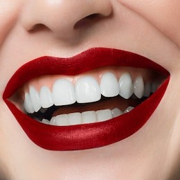beautiful smile with whitening teeth. dental photo. macro closeup of perfect female lipscare. perfect red lip makeup. perfect clean skin, light fresh lip make-up. isolated. good sunny mood