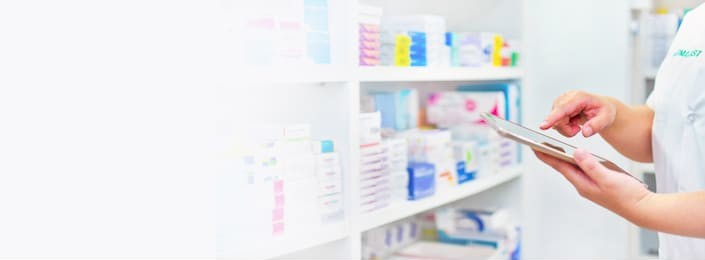 pharmacist holding computer tablet using for filling prescription in pharmacy drugstore. 