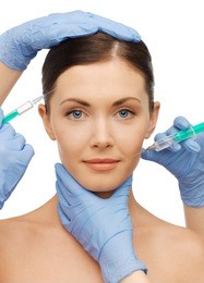picture of woman face and beautician hands with syringes