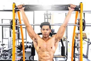 handsome muscular man working out hard at gym. training without shirt. chest exercises. chest workouts.