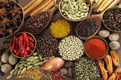 spices and herbs in metal  bowls and wooden spoons. food and cuisine ingredients.