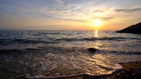 mesmerising wave during sunset at straits sea of malacca, malaysia.