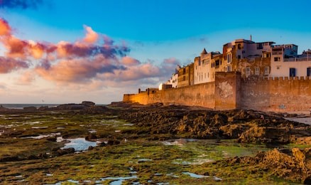 sunset at the old walls of essaouira castle on the atlantic coast in morocco, north africa.