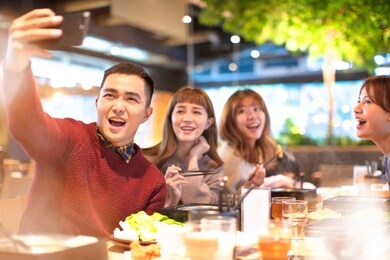 young group  taking selfie in the restaurant