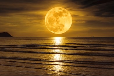 super moon. colorful sky with cloud and bright full moon over seascape in the evening. serenity nature background, outdoor at nighttime. the moon taken with my own camera.