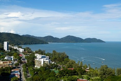aerial view of batu ferringhi beach and penang national park located in the malacca strait on penang island, malaysia. batu ferringhi is a popular travel destination for tourism.