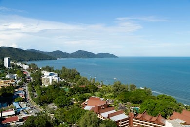 aerial view of batu ferringhi beach and penang national park located in the malacca strait on penang island, malaysia. batu ferringhi is a popular travel destination for tourism.