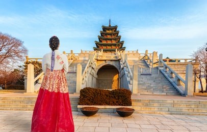 beautiful young asian woman traveler  in korean national dress or hanbok traveling into the gyeonbokgung  palace in seoul,south korea