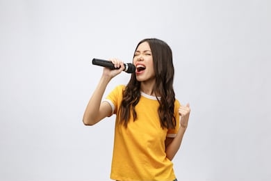 beautiful stylish woman singing karaoke isolated over white background.