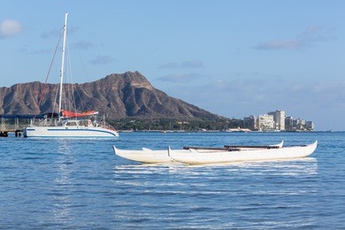 boat docked in front of diamond head and waikiki beach area of oahu in hawaii