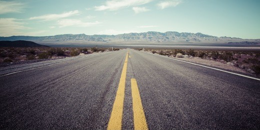 long desert highway to the mountains under the hot sun