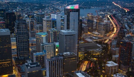 view of skyscrapers in downtown at night, in seattle, washington. rooftop panorama of night seattle