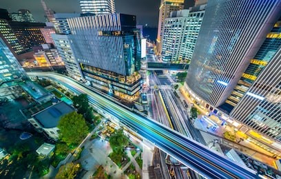 asia business concept for real estate and corporate construction - panoramic urban city aerial night view with crosstown traffic in ginza, tokyo, japan
