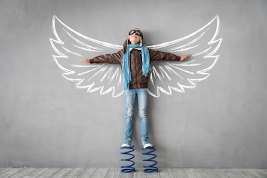 happy child standing on spring. success, creative and idea concept