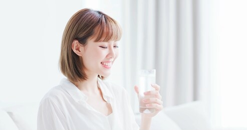 beauty woman drink water and feel happily at home