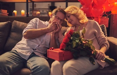 love has no age! romantic senior couple celebrating saint valentine's day at home. beautiful woman and handsome man enjoying spending time together. happy saint valentine's day!
