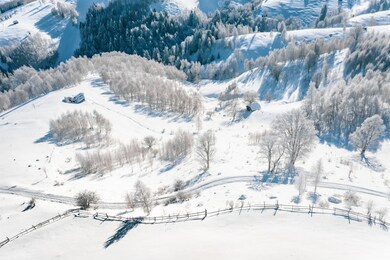 aerial view of a peasant village covered with snow in transylvania, romania