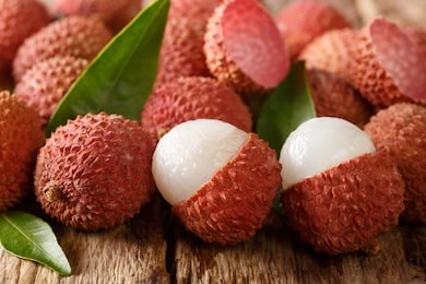 litchi, lichee, lychee, or lichi, litchi chinensis on old rustic wood background with copy space. horizontal

