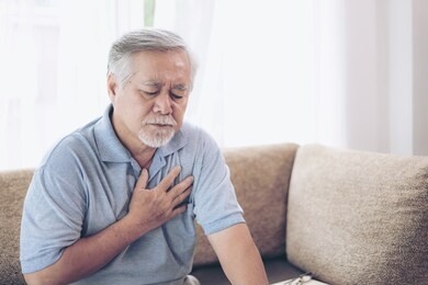 senior male asian suffering from bad pain in his chest heart attack at home - senior heart disease
