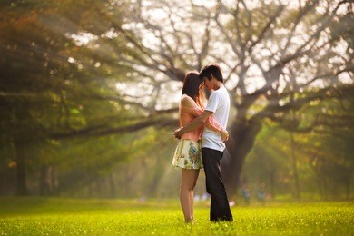 portrait of a young romantic couple embracing, outdoor portrait