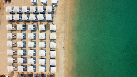 aerial top view photo of mykonos island paradise beach with sunbeds and umbrellas, cyclades, greece