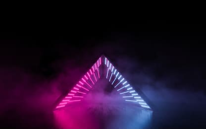 abstract triangular light tunnel background. glowing lines ultraviolet spectrum. pink and blue smoke and fog atmosphere on floor. fashion vibrant colors spectrum. 3d rendering.