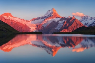 beautiful evening panorama from bachalp lake / bachalpsee, switzerland. picturesque summer sunset in swiss alps , grindelwald, bernese oberland, europe. 
beauty of nature concept background.