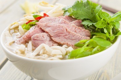 pho bo - vietnamese fresh rice noodle soup with beef, herbs and chili. vietnam's national dish.