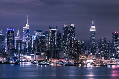 new york city manhattan skyline panorama at night over hudson river
