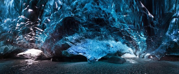 blue crystal ice cave and an underground river beneath the glacier. amazing nature of skaftafell, iceland. vatnajokull national park