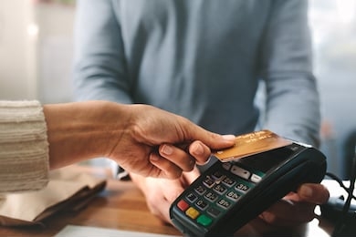 pharmacist accepting credit card by contactless payment.  woman purchasing products in the pharmacy. pharmacist hands charging with credit card reader.