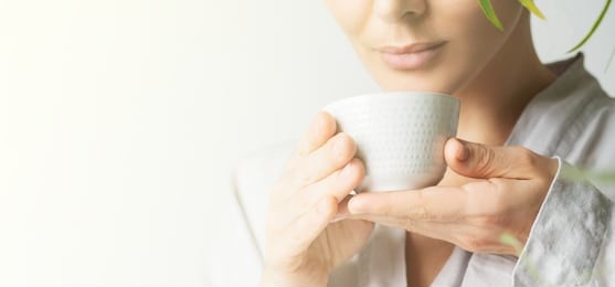 close view a beautiful woman holding teacup. asian food theme background with tea ceremony. brewing and drinking tea.