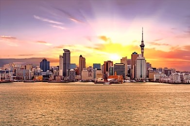 skyline photo of the biggest city in the new zealand, auckland. the photo was taken during the golden sunset across the bay